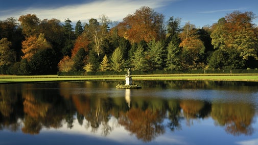 Late Autumn colours reflected in the water of Moon Pond at Studley Royal Water Garden, North Yorkshire